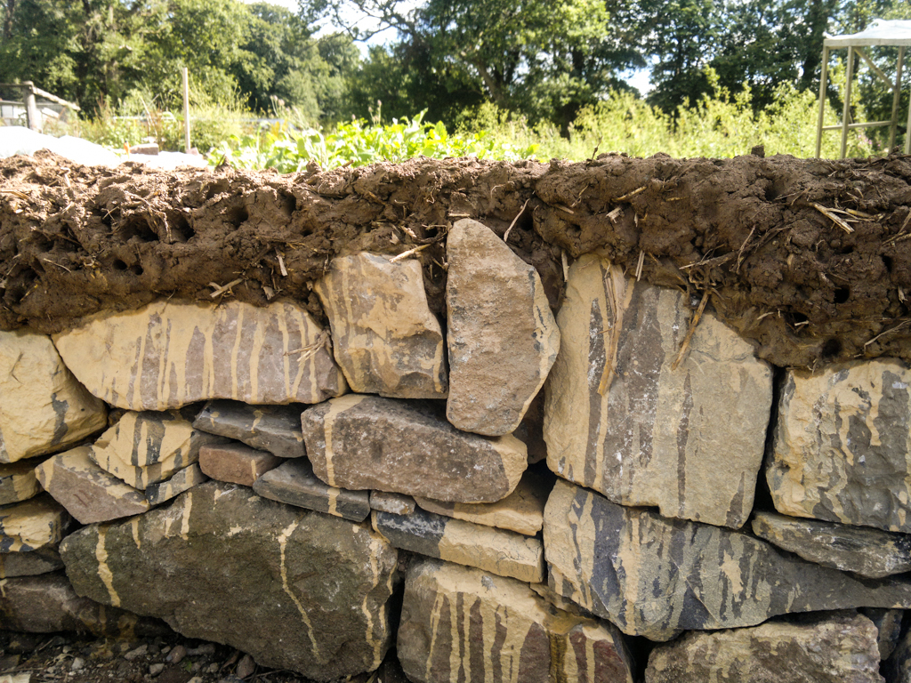 Detail of the dry-stone wall base (no cement used!) with the first layer of cob on top - the sculpture will be created using almost entirely natural materials, the only exception is the water-proof membrane on the roof